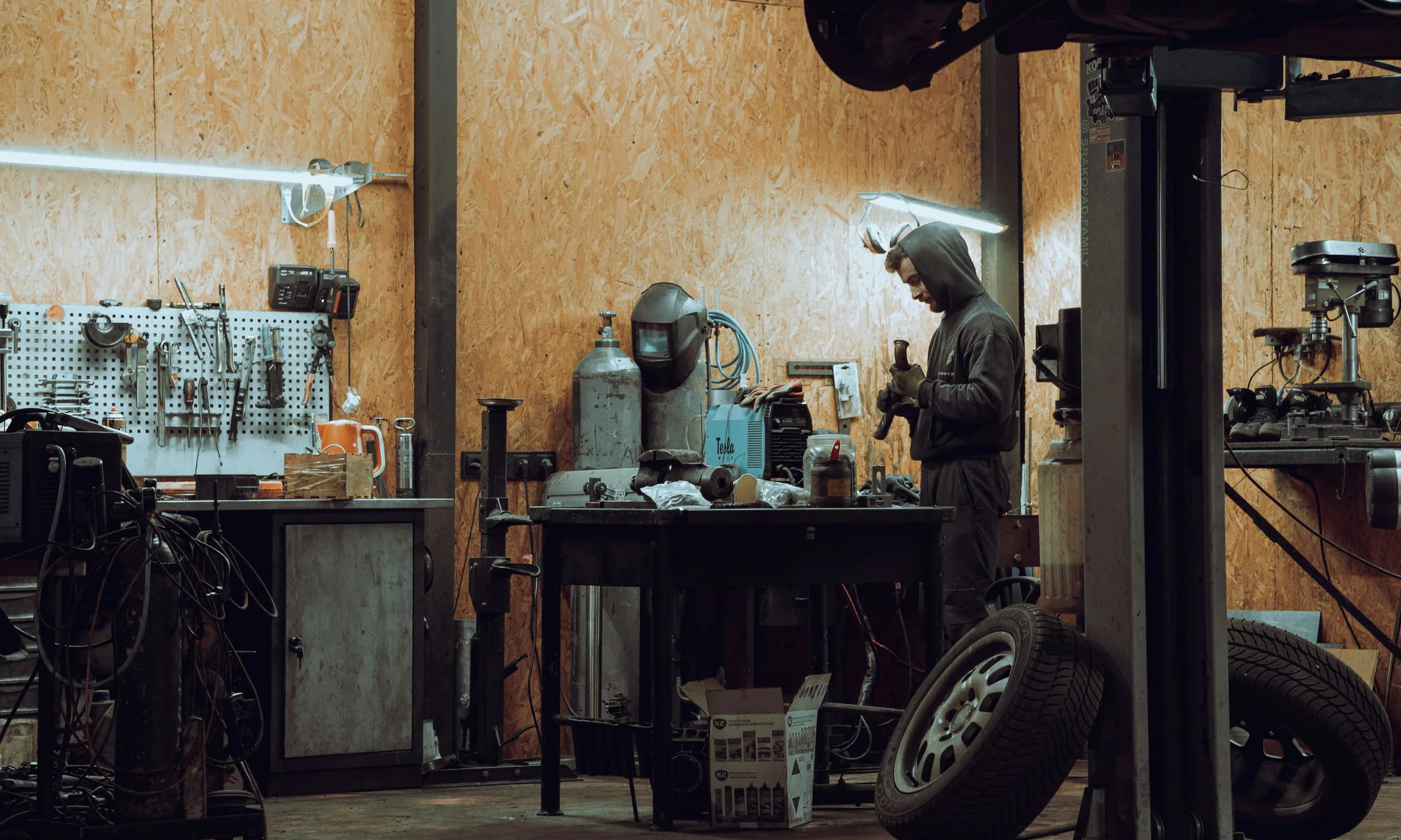 A mechanic working at a bench in an independent automotive workshop