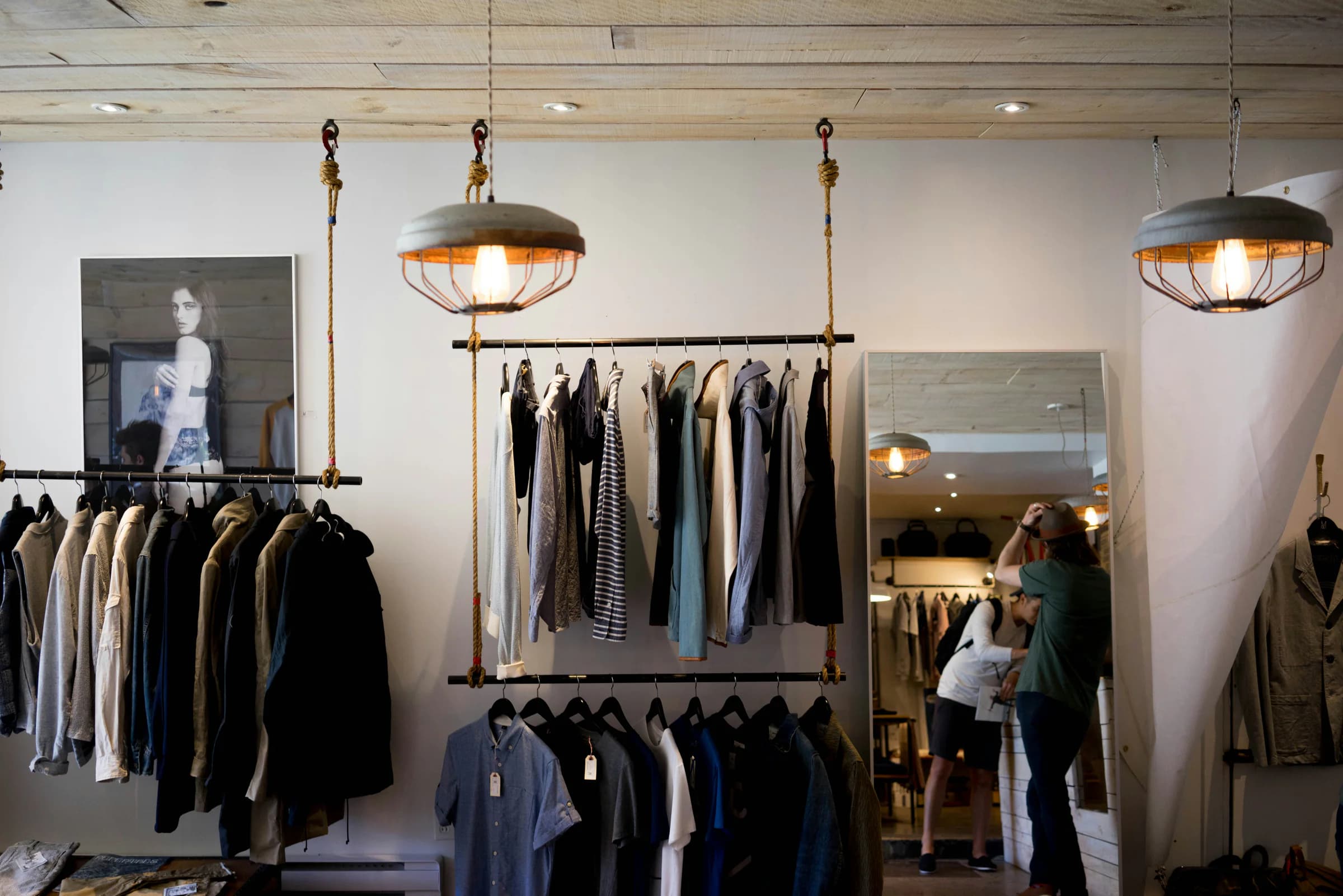A clothing boutique with garments arranged on hanging rails